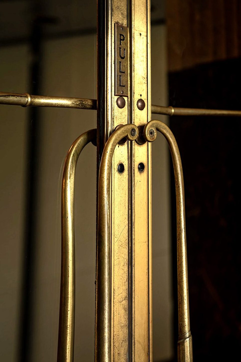 Exterior entrance bronze door handle and pull plate before restoration